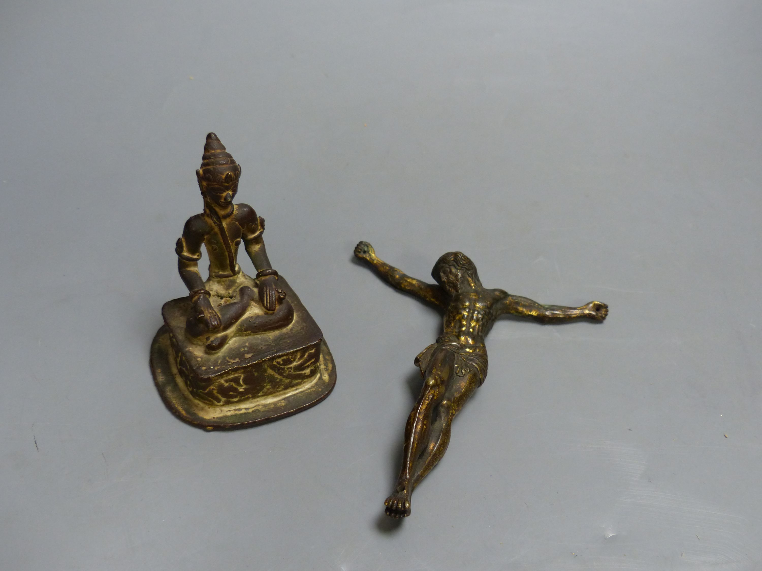 An Indian Buddhist figure and a gilt bronze Corpus Christi, largest 13cm